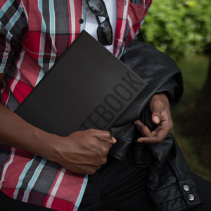 Young Man Holding Notebook