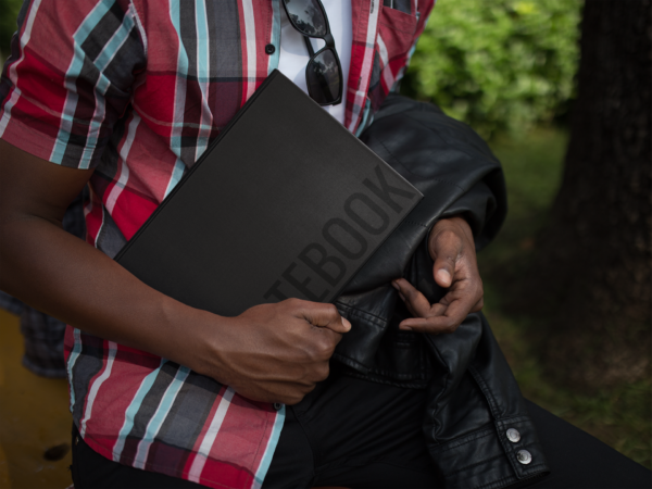 Young Man Holding Notebook